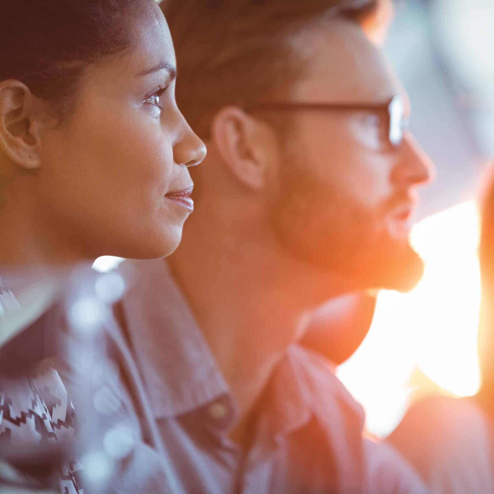 Side view of concentrated businesswoman sitting in meeting room
