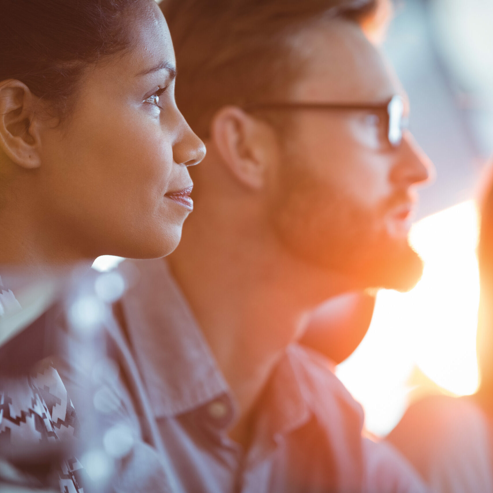 Side view of concentrated businesswoman sitting in meeting room